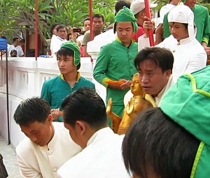 The Pra Bang is carried through the gates of Wat Mai, Luang Prabang, Laos