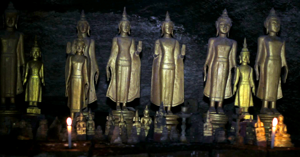 Some of the Buddha statues inside the caves at Pac Ou